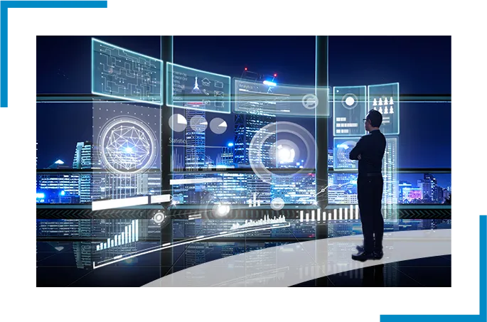 A man standing in the office looking at big screen